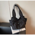 Detail of black nylon tote bag featuring drawstring pleats and side storage pocket - Black / One Size