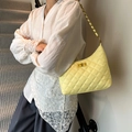 Chic cream quilted bucket bag with gold chain strap and turn-lock closure - Yellow