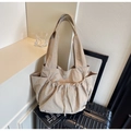 Close-up of beige tote bag with drawstring details and side pockets on luggage - Khaki / One Size