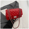 Detail of red quilted PU leather crossbody bag with silver chain strap and metal lock - Red