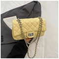 Detail of light yellow quilted bag with classic metal twist lock and chain strap - Yellow