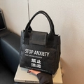 Black Dupont paper tote bag with Stop Anxiety print and waterproof crinkled texture - Black