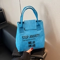 Blue Tyvek tote bag with Stop Anxiety slogan print and textured waterproof surface - Blue