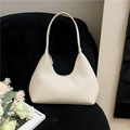 Elegant cream white textured leather hobo bag on a black corduroy chair background - Off White