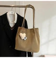 Detail of khaki suede tote bag featuring a white heart plush pendant and ribbon tag - Green with Pendant