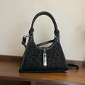 Chic black leopard print bucket bag with silver lock and detachable leather strap - Black
