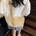 Minimalist beige nylon bucket bag with pleated texture and adjustable shoulder strap - Khaki