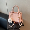 Pink marbled handbag with round knotted handles and white plush pompom charm - Pink