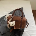 Brown leather Boston barrel bag with plush bear charm and adjustable shoulder strap - Coffee