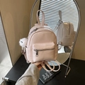 Pink mini PU leather backpack for women with white plush doll keychain in hand - Pink with Pendant