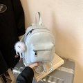 Mini light blue PU leather backpack for women featuring white plush charm and front pocket - Blue with Charm