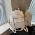 Cream textured leather backpack with silver zippers and V-pattern wide shoulder strap - Off-white
