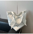 White canvas tote bag with silver star patterns and a large decorative bow detail - White