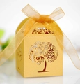 Close-up of golden hollow tree gift box with laser-cut details and organza ribbon - Gold