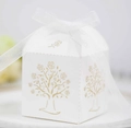 Detail of white paper gift box with gold foil tree pattern and white organza ribbon bow - Ivory