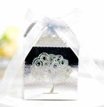 Detail of silver laser-cut candy box featuring tree of life pattern and white ribbon - Reflective Silver