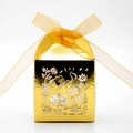 Detail of laser-cut golden favor box featuring intricate floral patterns and yellow silk ribbon - Reflective Gold