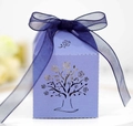 Detail of purple laser-cut candy box featuring rose tree patterns and blue organza ribbon - Sapphire Blue