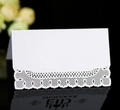 White Eid Mubarak laser cut place card with lace hollow design on black reflective surface - White