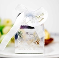 Macro shot of silver hollow gift box with rose pattern, Love cutout and white silk ribbon bow - Reflective Silver