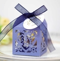 Detail of laser-cut purple gift box with LOVE pattern and navy blue ribbon on a plate - Sapphire Blue