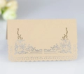 Elegant champagne gold laser-cut lace wedding place card on a soft grey background - Beige Gold