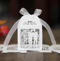 Detailed close-up of white laser-cut Mr & Mr wedding candy box with a sheer organza ribbon bow - White
