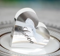 Close-up of heart-shaped silver gift box with Love hollow design and white organza ribbon - Reflective Silver