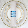 Blue laser-cut geometric napkin ring with reflective finish on pink satin fabric - Reflective Blue