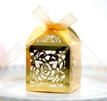Macro shot of gold hollow-out rose candy box with an elegant ribbon bow for wedding - Reflective Gold