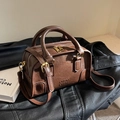 Vintage brown Boston bag in textured leather with gold hardware and embossed lettering - Coffee