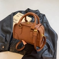 Vintage brown leather boston barrel bag with golden hardware and adjustable strap - Brown