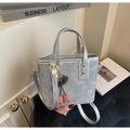 Detail of silver bucket bag with pearlescent texture and cherry charm accessory - Silver (With Cherry Pendant)