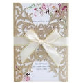 Golden glitter laser-cut floral wedding invitation with cream ribbon bow and floral insert - Glitter Rose Gold