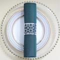 Silver hollow geometric metal napkin ring set on a dark green cloth for weddings - Reflective Silver