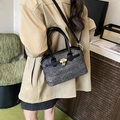 Grey tweed bucket bag with black leather trim and gold padlock detail shown on a model - Black