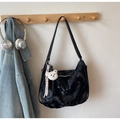 Detail of black tie-dye canvas hobo bag with teddy bear charm and leather strap - Black
