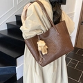 Large dark brown woven leather tote bag for women featuring a cute plush bear charm - With Charm / Brown