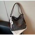 Detailed macro view of dark gray frosted tote bag with retro leather straps and side pendant - Black (With Pendant)