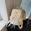 Beige nylon backpack with yellow embroidery and woven drawstring in a mirror reflection - Off-white