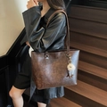 Vintage brown oil-wax leather tote bag with plush charm on a fashion model - Coffee (With Pendant)