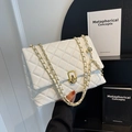 White quilted shoulder bag with gold chain strap and metallic ball pendant accessory - White