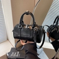 Black glossy oil-waxed leather pillow bag with silver hardware and adjustable strap - Black