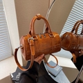 Stylish brown barrel-shaped handbag in polished faux leather with adjustable strap - Brown