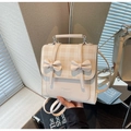 Cream beige plaid backpack featuring decorative 3D bows and versatile straps for women - Off-white