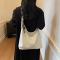Large cream tote bag in soft faux leather with woven tassel detail and adjustable strap - With Charm / White