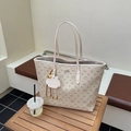 Beige Lazy Breeze tote bag with cartoon print, logo plaque, and matching charm on wood - Off White
