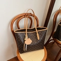 Large dark brown tote bag with Lazy Breeze logo print and cute charm on a wooden chair - Brown