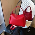 Vibrant red pebbled leather half-moon handbag with adjustable wide shoulder strap - Red