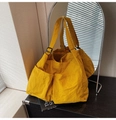 Detail view of large yellow tote bag with dual front pockets and adjustable strap - Yellow